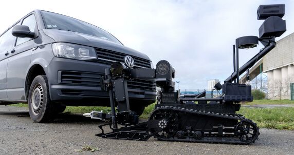 Atrax inspecting under a vehicle during training