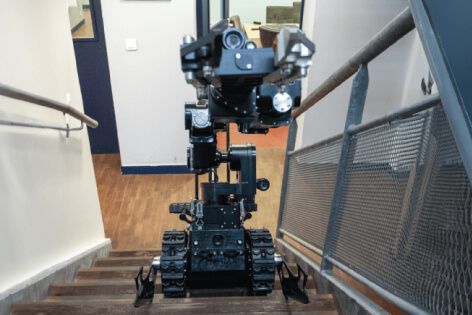 Close-up view of Atrax’s mechanical arm on stairs, showcasing precision handling capabilities.