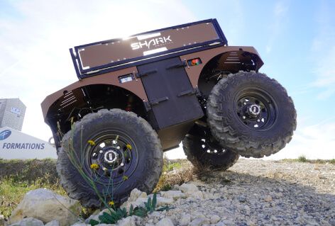 A close-up view of the Barakuda as it skillfully ascends a rocky hill, showcasing its rugged design and capabilities.