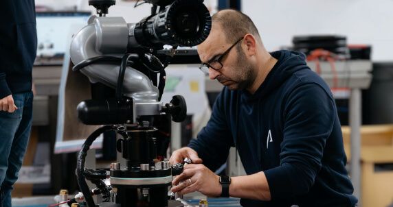 Technician working on the Colossus robot in our workshop.