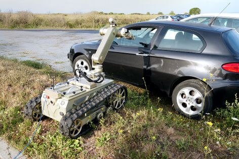 Rhyno EOD inspecting a vehicle seat for suspicious items, a practical demonstration of its inspection and threat-detection capabilities.